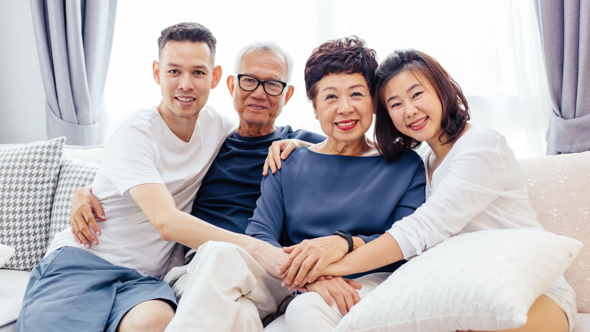 Family of aging parents and adult children smiling