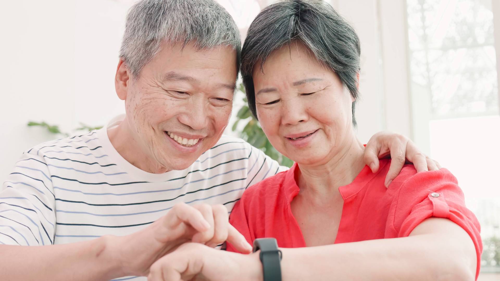 Senior couple looking at watch