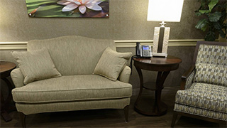 Table with lamp between couch and chair at Boonespring Transitional Care Center and Rehabilitation in Boone Co., KY
