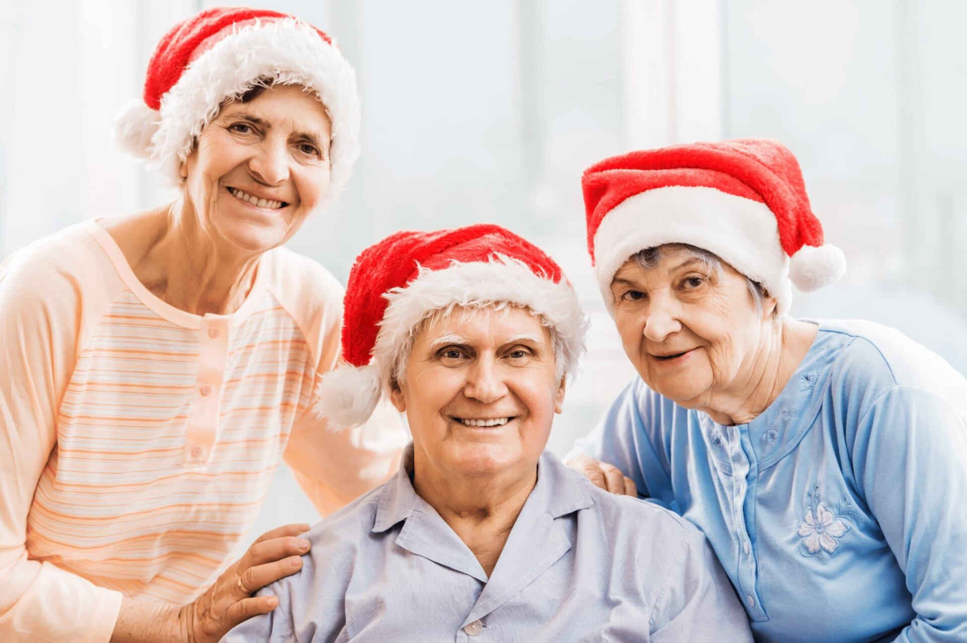 Senior friends wearing santa hats smiling