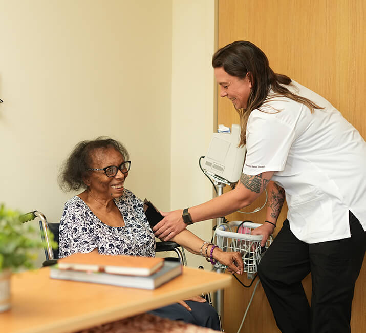 Nurse assisting senior woman