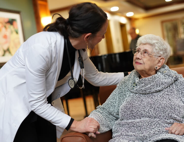 Nurse checking in with senior woman