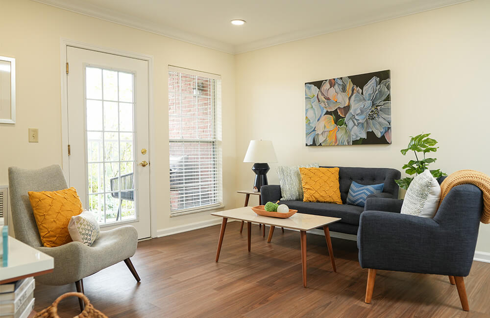 Modern living room with stylish furniture and floral artwork on the wall.