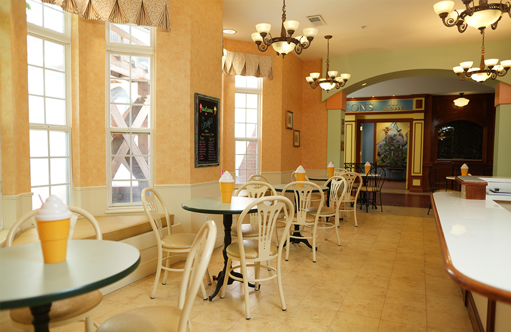 Inviting dining hall with tables, chairs, and ice cream cone decorations.