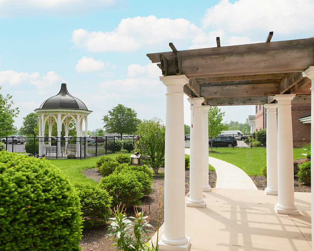 Garden view with gazebo and pergola in a senior community.
