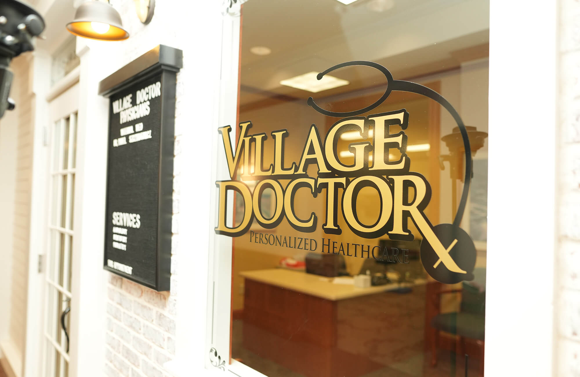Window with Village Doctor sign in senior living community unit.