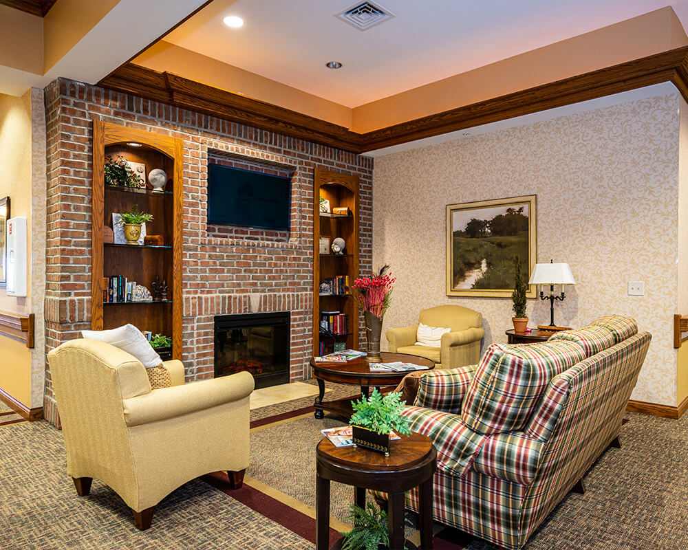 Cozy community lounge with comfortable seating and a fireplace.