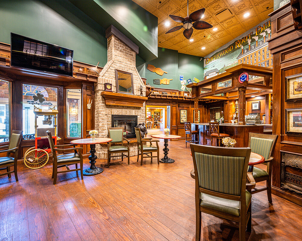 Cozy seating area with fireplace in a vibrant senior community common room.