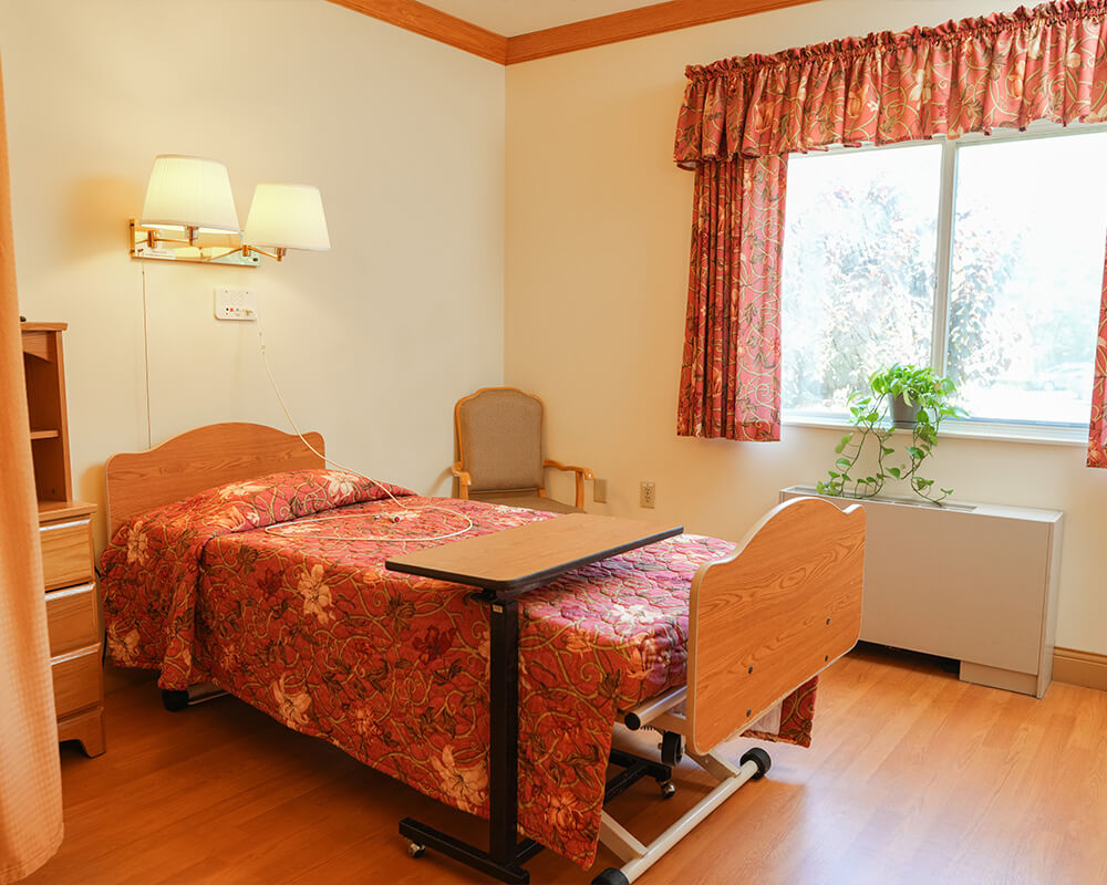 Comfortable resident room with a window and view.