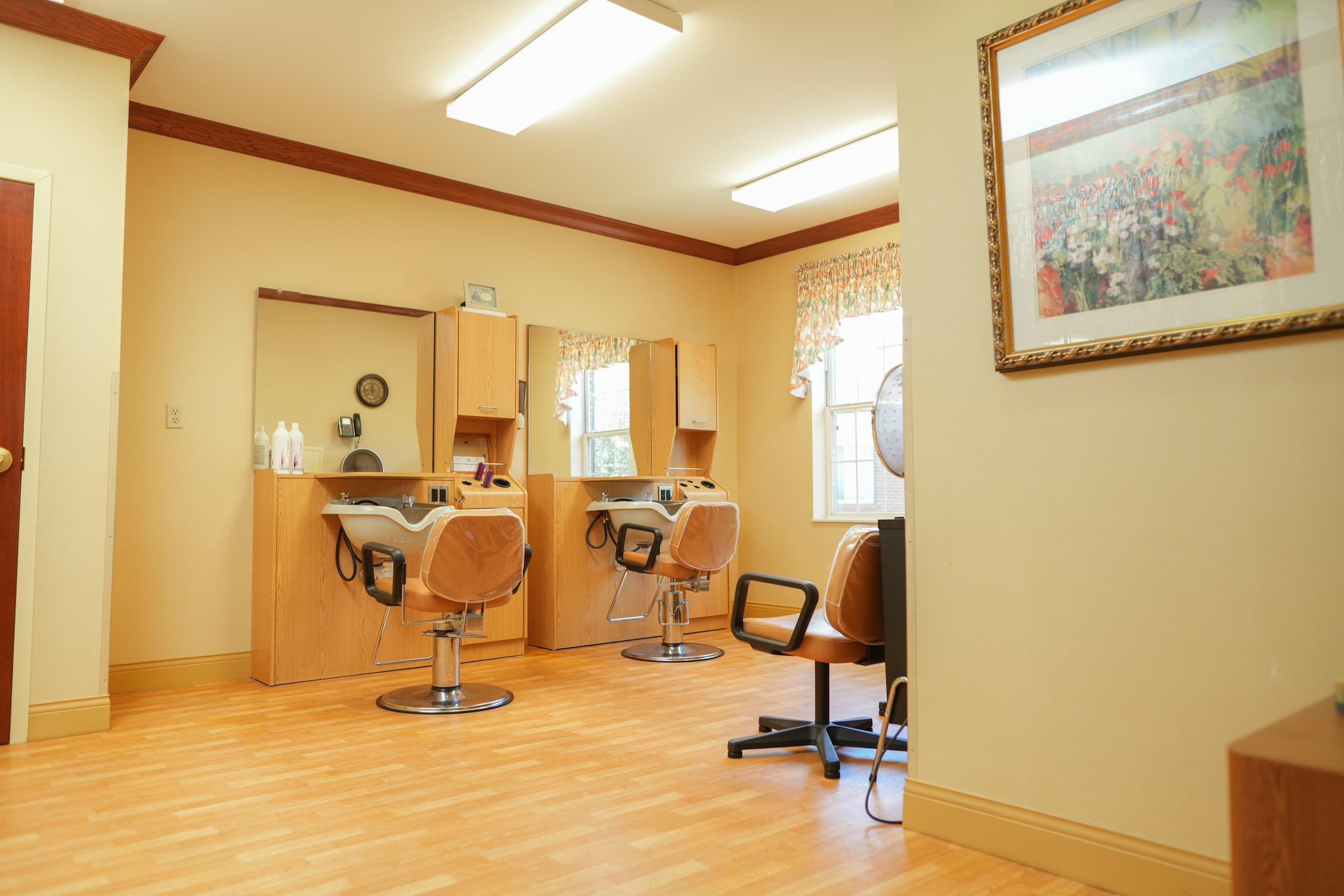 Well-lit salon in senior community with styling chairs and mirrors.
